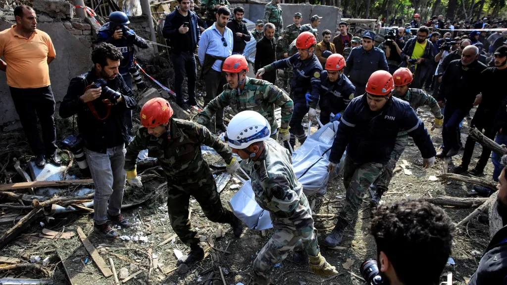 Záchranáři vynášejí oběť z trosek v ázerbájdžánském městě Gjandža