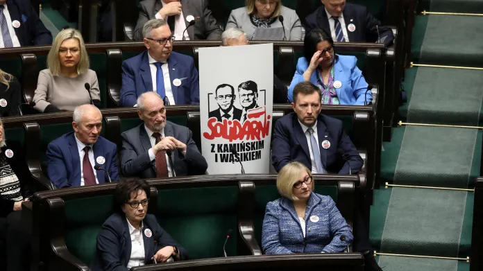 Poslanci strany PiS s plakátem na podporu Mariusze Kamińského a Macieje Wąsika