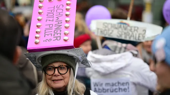 Ženy s pokrývkou hlavy s nápisem „Těhotná navzdory pilulce proti otěhotnění?“ (vlevo) a „Těhotná navzdory nitroděložnímu antikoncepčnímu tělísku?“ demonstrují za legalizaci potratů 7. prosince 2024 v Berlíně. Němečtí aktivisté usilují o reformu, která by odstranila právní překážky pro ženy žádající o interrupci, přičemž emoce jsou v této otázce zjitřené v době, kdy se země blíží k předčasným volbám.