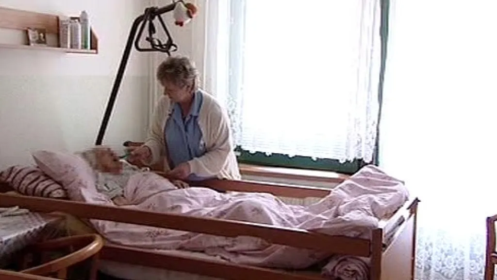 Ošetřovatelka pomáhá seniorce s jídlem