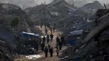 Palestinci se procházejí mezi hromadami sutin (19. listopadu 2025)