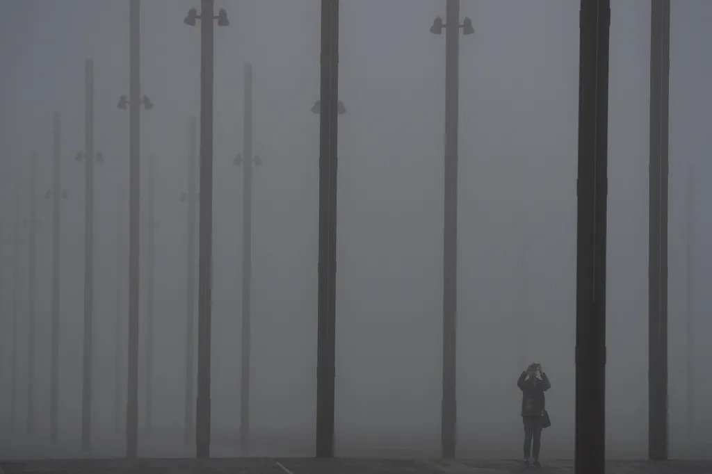 Muž fotografující hustou mlhu v severoirském Belfastu