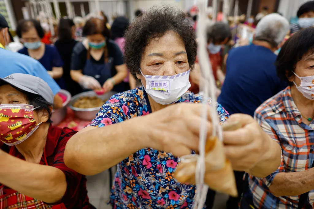 Lidé se scházejí k přípravě tradičních rýžových knedlíčků před každoročním festivalem dračích lodí v Taoyuanu na Tchaj-wanu