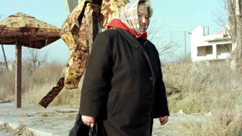 Obyvatelka Vukovaru před zničenou vodárenskou věží