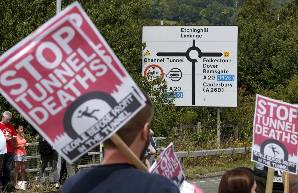 Protesty na znamení solidarity s migranty v britském Folkestone (1. srpna 2015). Demonstranti naléhají na Eurotunel, aby přijal větší bezpečnostní opatření a pomohl tak zabránit dalším úmrtím lidí, kteří se pokoušejí dostat do Británie