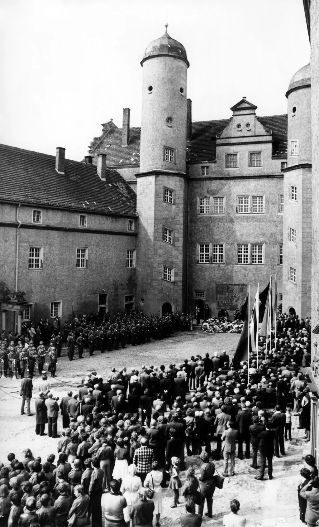 Mezi první místa, kde byl umístěn koncentrační tábor, patřil hrad Lichtenburg v malém městečku Prettin ve východním Německu. Tábor byl otevřen v roce 1933. Fotografie zachycuje pietní akci, která se na hradě uskutěčnila v roce 1978