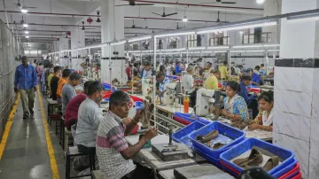 Dělníci v indické továrně vyrábějí koženou obuv