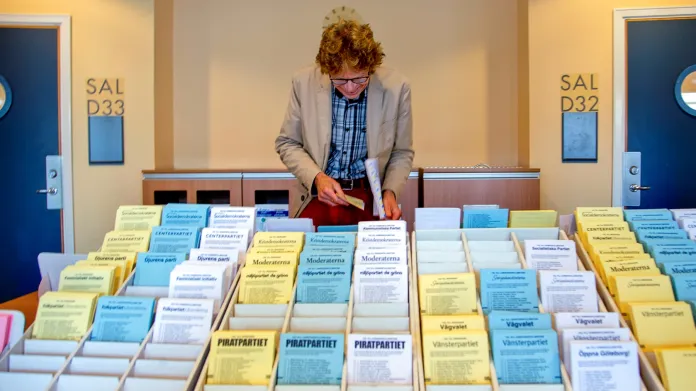 Muž ve volební místnosti v Göteborgu si vybírá z kandidátek