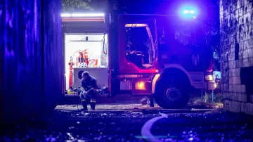 Člen záchranných složek odpočívá po zásahu u požáru budovy v Kyjevě