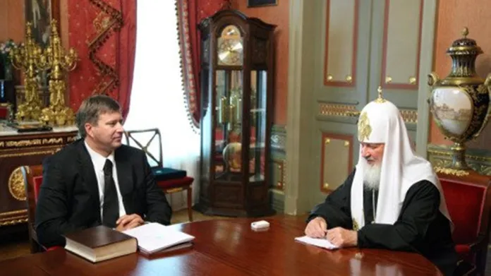 Fotografie z roku 2012, na níž grafici pravoslavné církve vyretušovali drahé hodinky patriarchy Kirilla jen na ruce, a ne na odrazu na stole