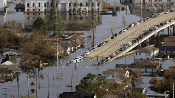 Opuštěné automobily v řadě na zaplavené dálnici po evakuaci New Orleans.