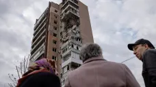 Místní obyvatelé před bytovým domem v Charkově, který zasáhl ruský útok z noci na 4. dubna 2024