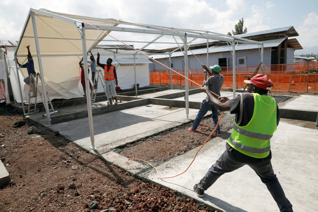 Dělníci staví konstrukci nového centra pro boj s ebolou ve městě Goma. Výstavba je  financována organizací Lékaři bez hranic.
