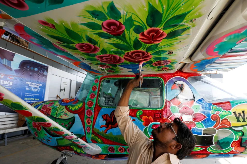 Malíři zdobí letadla Cessna v jednom z hangárů na mezinárodním letišti v pákistánském Karáčí