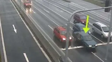 Vůz projíždějící na červenou mezi stojícími auty