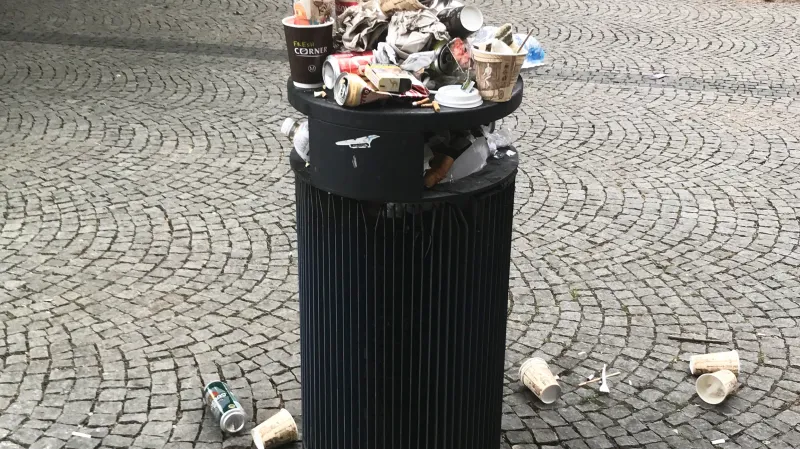 Přeplněný koš před hlavním nádražím v Olomouci (20. 6. 2019)