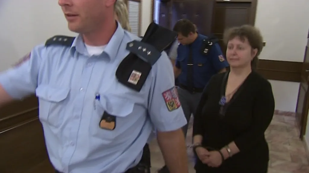 Policie přivádí obžalovanou lékárnici