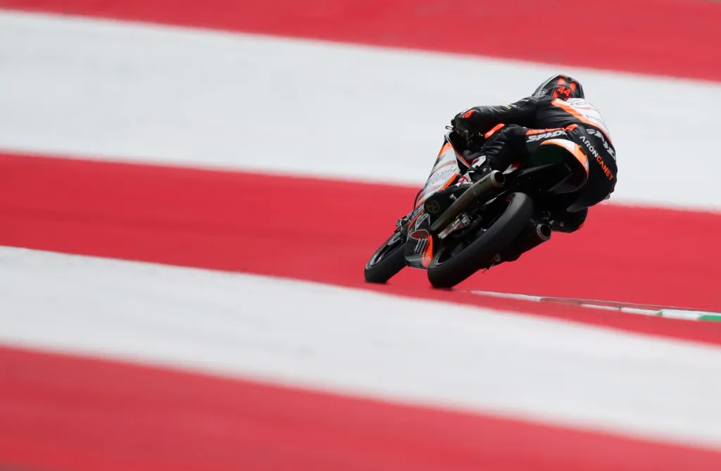 Snímek závodníka přejíždějícího pruhy během závodů Moto 3 není fotomontáž, i když by to tak mohlo na první pohled vypadat