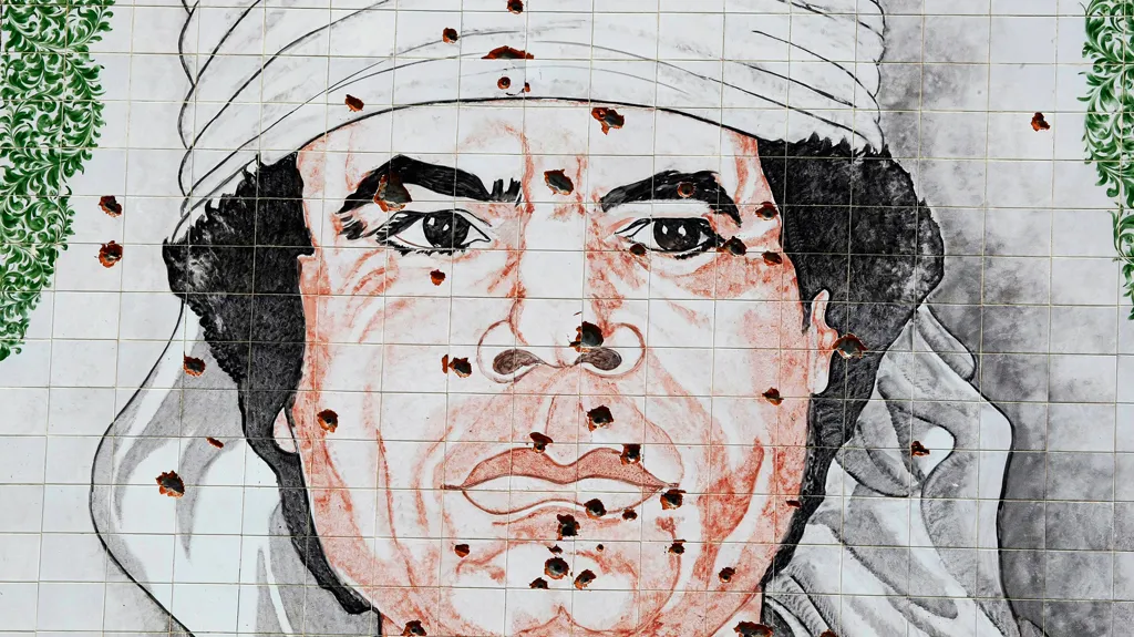 Rozstřílený portrét Muammara Kaddáfího v Tripolisu