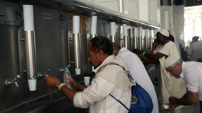 Poutníci pijí vodu zamzam ve Velké mešitě
