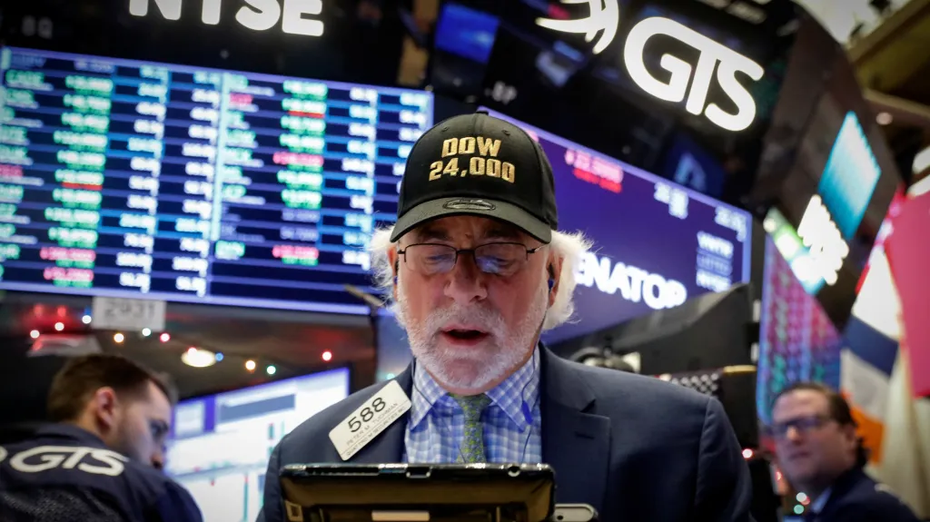 Obchodník na parketu newyorské akciové burzy NYSE. Jeho čepice připomíná překonání hranice 24 000 bodů