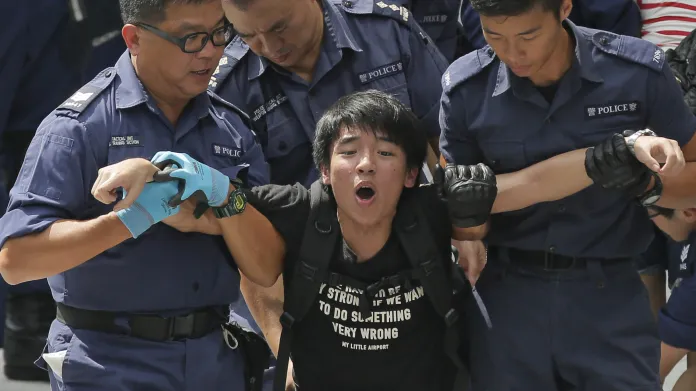 Policie odvádí demonstrujícího studenta od sídla vlády