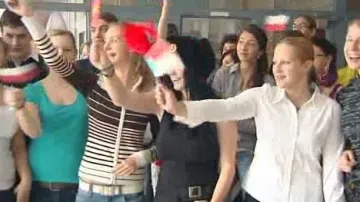 Studenti vítající hosty s mávátky