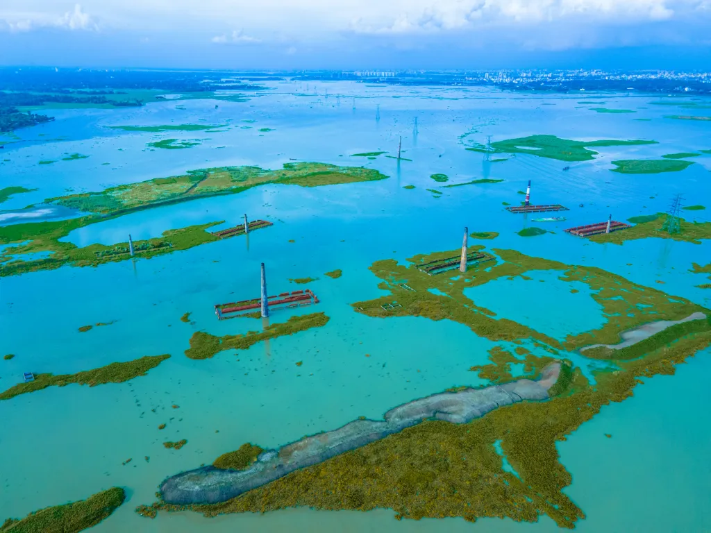 Cihláři z bangladéšského Savaru zachraňují během záplav nevypálené cihly, které by se ve vodě rychle rozpadly