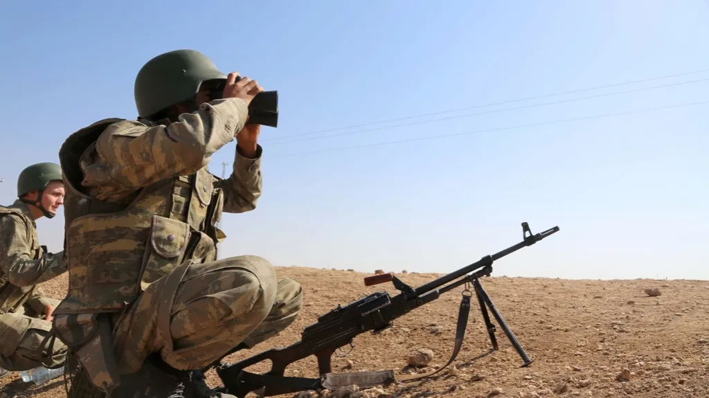 Kurdští vojáci sledují bojovou frontu
