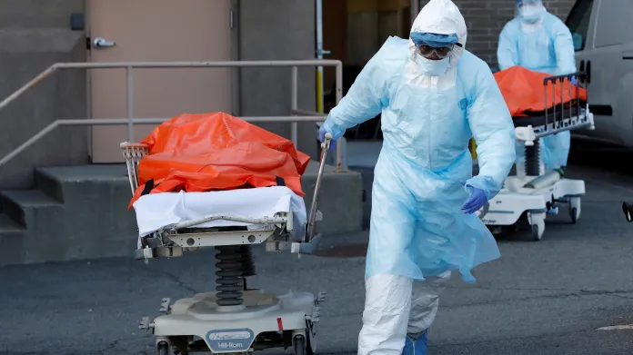 Zdravotníci z nemocnice v Brooklynu odvážejí těla obětí nemoci COVID-19