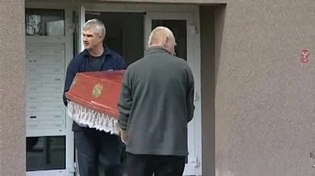 Pracovníci pohřební služby odváží mrtvá těla