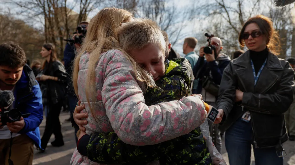 Ukrajinka Iryna objímá syna Bohdana, který se vrátil z Ruska poté, co tam byl odvlečen z letního tábora na okupovaném ukrajinském území