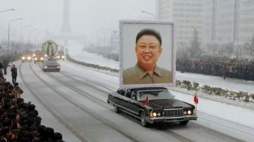 Pohřební vůz s obřím portrétem Kim Čong-ila