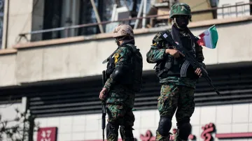 Ozbrojenci dohlížejí na shromáždění příznivců nového íránského duchovního vůdce Modžtaby Chameneího