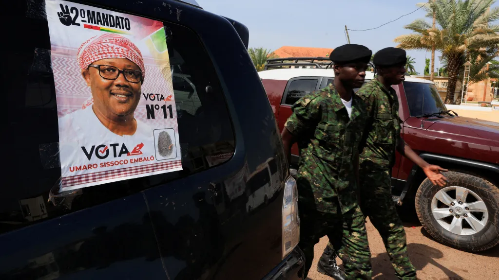 Vojáci vedle volebního plakátu prezidenta Guineje-Bissau Umara Sissoca Embalóa