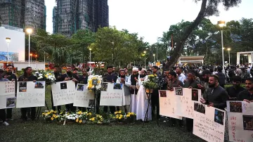 Lidé se modlí za oběti smrtícího požáru v bytovém komplexu v Hongkongu