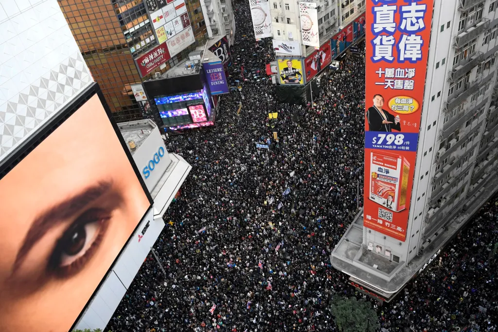 Příznačné „velké oko“ sleduje protivládní demonstranci v Hongkongu na obranu lidských práv
