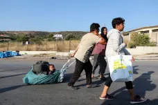 Řecká policie přesouvá migranty ze zničené Morie do nového tábora. Někteří se k přesunu staví neochotně