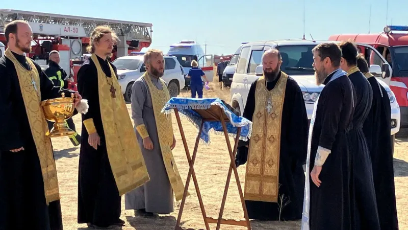 Pravoslavní kněží u místa požáru v ruském Proletarsku