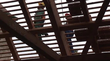 Dělníci dokončují poslední část střechy ovčína