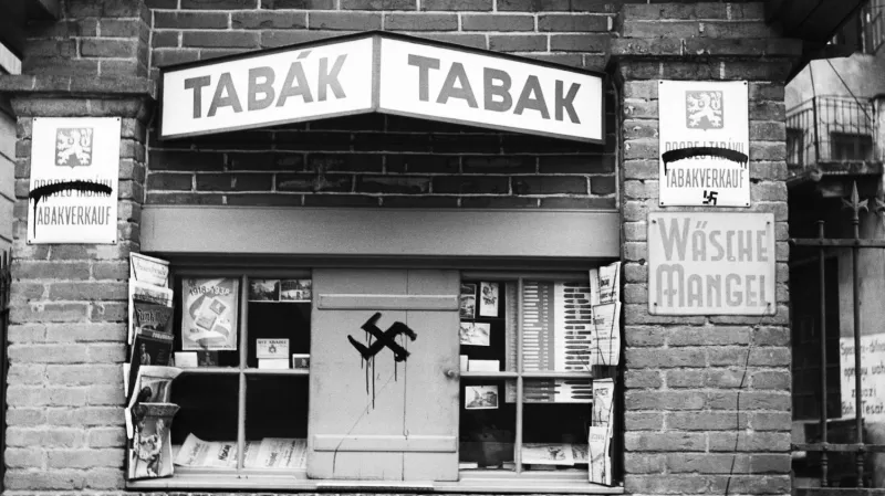 Trafika v pohraničí během sudetského povstání s načmáraným hákovým křížem a přeškrtanými českými nápisy